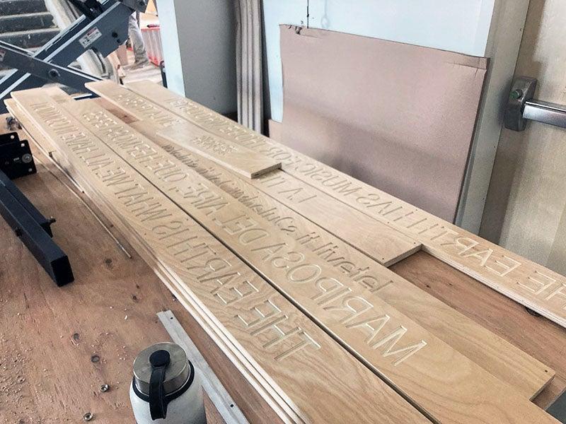 a pile of boards have words engraved on them