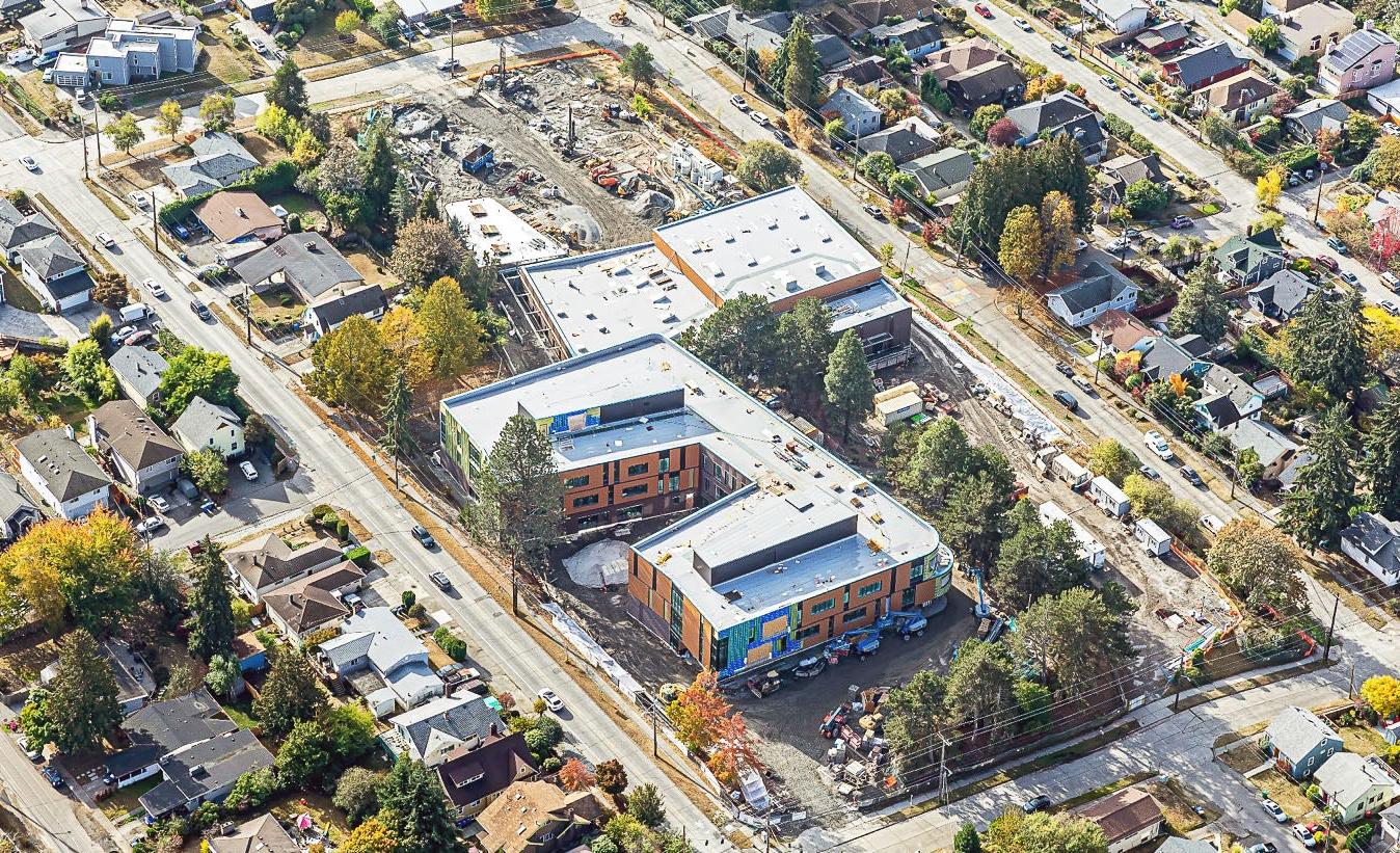 aerial photo of two large connected buildings with outdoor construction work happening